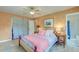 Bright bedroom with a ceiling fan, an adjacent bathroom and a window with white sheer curtains at 2506 Birkenhead Dr, Charleston, SC 29414