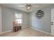 Empty bedroom with a small table and chair set next to a bright window and a ceiling fan at 2506 Birkenhead Dr, Charleston, SC 29414