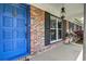 Inviting front porch featuring a blue door, brick accents, and classic lighting at 2506 Birkenhead Dr, Charleston, SC 29414