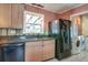 Cozy kitchen features wood cabinets, stainless steel appliances, and an adjacent laundry area for convenience at 2506 Birkenhead Dr, Charleston, SC 29414