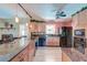 Modern kitchen with granite countertops, stainless steel appliances, custom cabinets, and a ceiling fan at 2506 Birkenhead Dr, Charleston, SC 29414