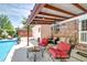 Inviting covered patio area with a fire pit, outdoor seating, and pool access, ideal for outdoor entertaining at 2506 Birkenhead Dr, Charleston, SC 29414