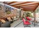 Covered outdoor patio with comfortable seating, string lights, and brick accents, perfect for relaxation at 2506 Birkenhead Dr, Charleston, SC 29414