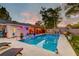 Backyard pool at dusk featuring chaise lounge chairs, an outdoor lounge area, and decorative outdoor lighting at 2506 Birkenhead Dr, Charleston, SC 29414