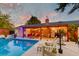 Backyard pool with string lights and an outdoor lounge area with a brick fireplace at 2506 Birkenhead Dr, Charleston, SC 29414