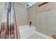 Shower with beige tiled walls, a built-in soap dish, and a decorative shower curtain at 2506 Birkenhead Dr, Charleston, SC 29414