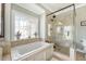 Bright bathroom featuring a soaking tub with decorative window and a glass-enclosed shower at 2640 Crooked Stick Ln, Mount Pleasant, SC 29466