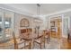 Elegant dining room with hardwood floors, a stylish chandelier, and french doors at 2640 Crooked Stick Ln, Mount Pleasant, SC 29466