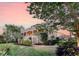 Beautiful low angle exterior view of the house, showcasing its lush landscaping and multiple stories at 2640 Crooked Stick Ln, Mount Pleasant, SC 29466