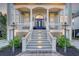 Beautiful front entrance with a blue door, white columns, and manicured landscaping at 2640 Crooked Stick Ln, Mount Pleasant, SC 29466