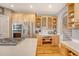Well-appointed kitchen with stainless appliances, custom cabinetry, and an island cooktop at 2640 Crooked Stick Ln, Mount Pleasant, SC 29466
