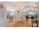 Elegant living room, seamlessly connected to the dining area, featuring hardwood floors and golf course view at 2640 Crooked Stick Ln, Mount Pleasant, SC 29466