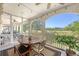 Cozy screened-in porch featuring dining furniture, ceiling fan, and a scenic golf course view at 2640 Crooked Stick Ln, Mount Pleasant, SC 29466