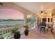 Covered porch featuring a ceiling fan, string lights, and a golf course view at 2640 Crooked Stick Ln, Mount Pleasant, SC 29466