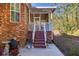 Charming back porch entrance with brick accents, steps and access to a screened in area, adding character to the exterior at 2800 Waterpointe Cir, Mount Pleasant, SC 29466