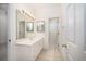 Well-lit bathroom with vanity, framed mirrors, and a door leading to the toilet and shower area at 2800 Waterpointe Cir, Mount Pleasant, SC 29466