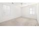 Bright bedroom with neutral carpet, two windows with shutters, and ceiling fan at 2800 Waterpointe Cir, Mount Pleasant, SC 29466