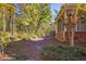Exterior view from side yard with brick home with screened-in porch and mature trees adding to the property's appeal at 2800 Waterpointe Cir, Mount Pleasant, SC 29466