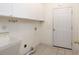 Laundry room with white cabinetry, utility sink, and tile flooring at 2800 Waterpointe Cir, Mount Pleasant, SC 29466