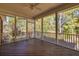 Spacious screened porch with wood flooring offers a tranquil outdoor living space with views of the surrounding landscape at 2800 Waterpointe Cir, Mount Pleasant, SC 29466