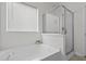 Clean bathroom featuring a soaking tub, a glass-enclosed shower, and a window for natural light at 2911 Penobscot Dr, North Charleston, SC 29420