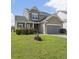 Charming two-story home featuring a well-manicured lawn and attached two-car garage at 2911 Penobscot Dr, North Charleston, SC 29420