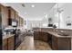 Open kitchen showcases dark wood cabinets, granite counters, and flows seamlessly into the living space at 2911 Penobscot Dr, North Charleston, SC 29420