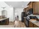 Functional kitchen features black appliances, wood cabinetry, granite countertops, and a view to the dining room at 2911 Penobscot Dr, North Charleston, SC 29420