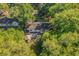 Aerial view of a home's backyard, including a covered patio and mature landscaping at 2988 Bolton Rd, Charleston, SC 29414