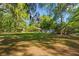 Lush backyard with mature trees, a covered patio, and expansive green space perfect for recreation at 2988 Bolton Rd, Charleston, SC 29414