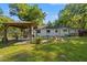 Expansive backyard features a covered patio area, mature landscaping, and ample green space at 2988 Bolton Rd, Charleston, SC 29414