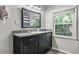 Classic bathroom with a granite countertop, framed mirror, and natural light from the window at 2988 Bolton Rd, Charleston, SC 29414