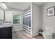 This bathroom features a granite countertop, shower with a striped curtain, and a window at 2988 Bolton Rd, Charleston, SC 29414