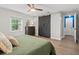 This comfortable bedroom features a ceiling fan, a modern barn door, and wood flooring at 2988 Bolton Rd, Charleston, SC 29414