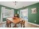 Bright dining area with a wooden table, eclectic chairs, and view to the next room at 2988 Bolton Rd, Charleston, SC 29414