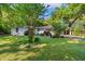 Charming one-story home with a well-manicured lawn and mature trees offering shade and curb appeal at 2988 Bolton Rd, Charleston, SC 29414
