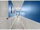 Hallway with blue walls, white trim, and neutral flooring, creating a calming and elegant transition space at 2988 Bolton Rd, Charleston, SC 29414