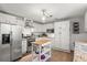 Charming kitchen with white cabinets, stainless steel appliances, butcher block island, and granite countertops at 2988 Bolton Rd, Charleston, SC 29414