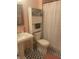 Well-lit bathroom with a pedestal sink, toilet, and storage, complemented by stylish patterned tile flooring at 309 Meeting St # 8, Charleston, SC 29401