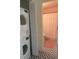 Compact bathroom features a stackable washer/dryer adjacent to the bathroom with patterned tile flooring at 309 Meeting St # 8, Charleston, SC 29401