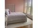 Cozy bedroom featuring hardwood floors, soft lighting, stained glass windows and a view into living area at 309 Meeting St # 8, Charleston, SC 29401