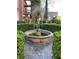 Classic style fountain surrounded by manicured garden and brick pavers at 309 Meeting St # 8, Charleston, SC 29401