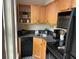 Efficient kitchen with black appliances, black countertops and mosaic floor tile at 309 Meeting St # 8, Charleston, SC 29401