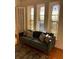 Charming living room featuring original stained glass windows, hardwood floors, and a cozy seating area at 309 Meeting St # 8, Charleston, SC 29401