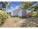 A spacious backyard features lush greenery and a building with blue siding and a brick foundation at 3364 Osceola St, North Charleston, SC 29405