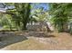 The backyard shows a rustic barrel sitting on a spacious lot with mature trees at 3364 Osceola St, North Charleston, SC 29405