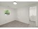 This well-lit bedroom features wood floors, an ensuite bathroom and a window at 3364 Osceola St, North Charleston, SC 29405