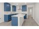 Bright kitchen boasts blue cabinets, stainless hood, an island and plenty of counter space at 3364 Osceola St, North Charleston, SC 29405