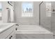 A view of the soaking tub and tiled shower with glass door in a modern bathroom at 361 Ripple Park Dr, Summerville, SC 29486