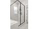Close up of tiled shower with black trim and glass door in a modern bathroom at 361 Ripple Park Dr, Summerville, SC 29486